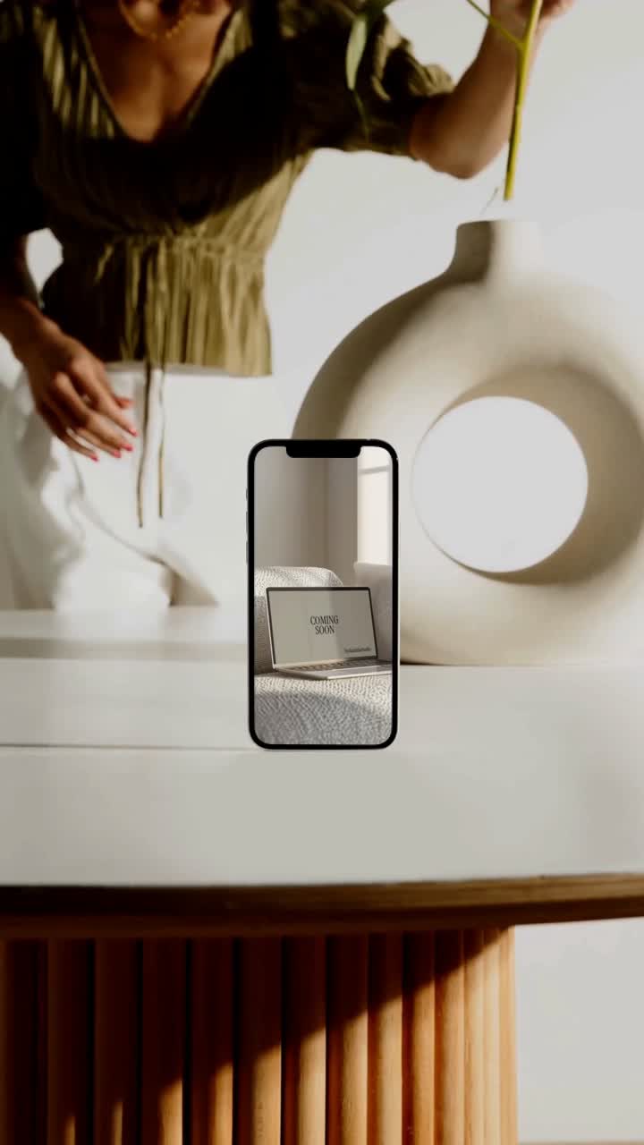 Phone displaying social content on a styled table
