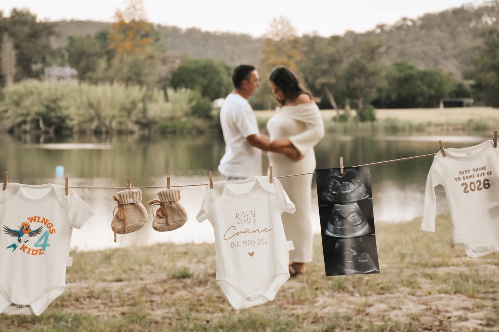 Expecting couple with baby clothes hung on a line