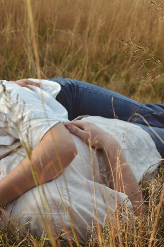 Expecting mother lying in long grass